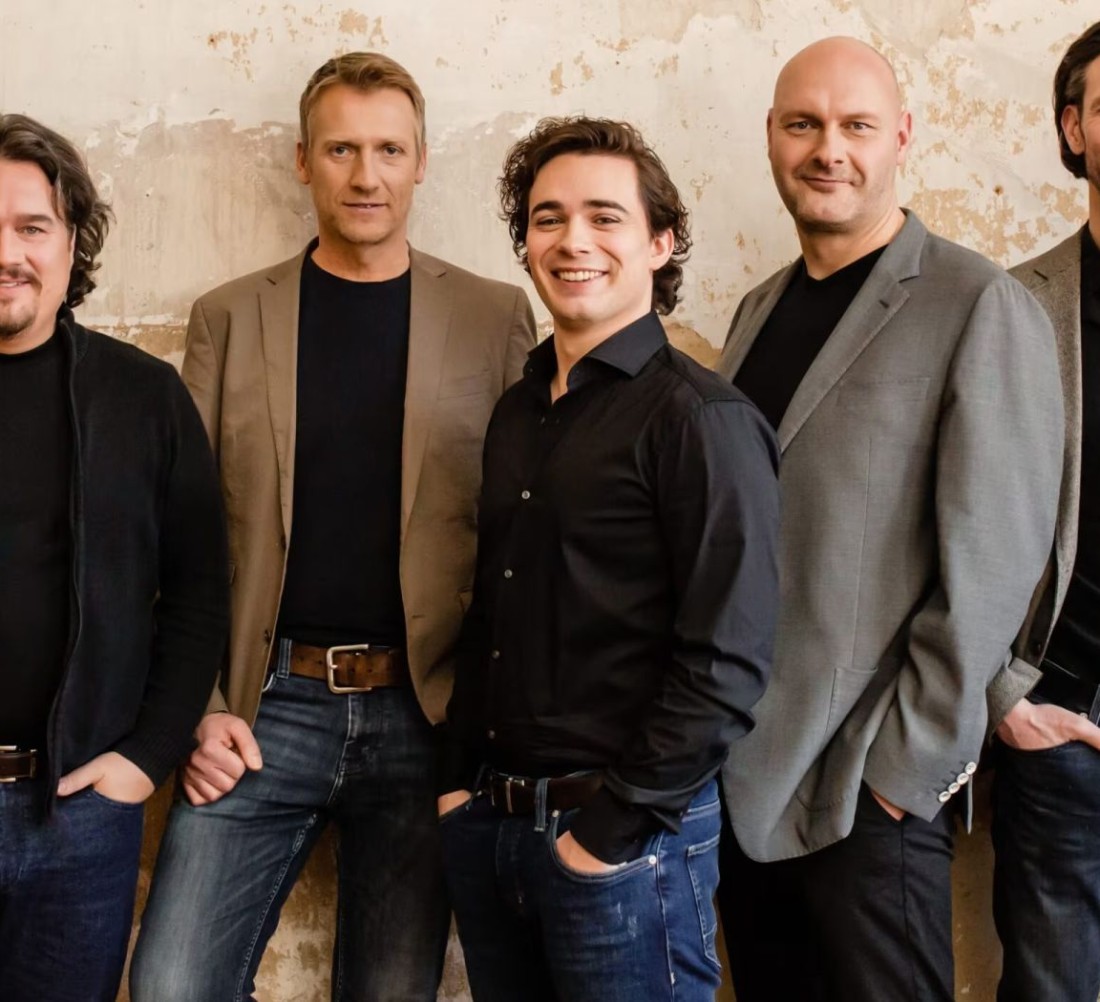 Foto von fünf Männern vor einer Wand